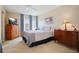 Cozy bedroom with carpeted flooring, wooden dresser, and a TV at 2740 Highlands Blvd # D, Palm Harbor, FL 34684