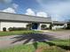 Clubhouse exterior with palm tree shadows at 2740 Highlands Blvd # D, Palm Harbor, FL 34684