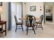 Dining room with round table and chairs, white tile floors, and natural light at 2740 Highlands Blvd # D, Palm Harbor, FL 34684