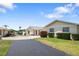 Exterior view of a home with a driveway, lawn, and shrubs at 2740 Highlands Blvd # D, Palm Harbor, FL 34684