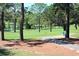 Lush green golf course with a tranquil pond and mature trees at 2740 Highlands Blvd # D, Palm Harbor, FL 34684