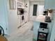 Bright galley kitchen with white cabinets, white appliances, and tile floors at 2740 Highlands Blvd # D, Palm Harbor, FL 34684