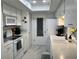 Updated kitchen with white cabinetry, plenty of counter space, and modern appliances at 2740 Highlands Blvd # D, Palm Harbor, FL 34684