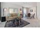 Living and dining area with a sofa, dining table, and tiled floor at 2740 Highlands Blvd # D, Palm Harbor, FL 34684