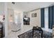 Living room with white tile floors, murphy bed, and sliding glass doors at 2740 Highlands Blvd # D, Palm Harbor, FL 34684