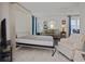 Bedroom with a Murphy bed, sofa, armchair, and tiled floor at 2740 Highlands Blvd # D, Palm Harbor, FL 34684