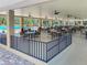 Covered poolside dining area with tables, chairs, and ceiling fans at 2740 Highlands Blvd # D, Palm Harbor, FL 34684