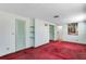 Bedroom with red carpet, closet, and wall decor at 4403 Northrop Ter, Tampa, FL 33618