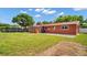 Spacious backyard with a terracotta-colored house and green lawn at 4600 16Th N St, St Petersburg, FL 33703