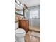 Updated bathroom with granite countertops, wood cabinetry, and a sliding glass shower door at 4600 16Th N St, St Petersburg, FL 33703