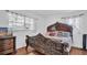 Bedroom featuring an ornate bed, wood flooring, windows with lace curtains, and a wood dresser at 4600 16Th N St, St Petersburg, FL 33703