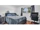 Modern bedroom with a blue bedspread, black headboard, wood floor, window, and a desk at 4600 16Th N St, St Petersburg, FL 33703