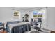 Bedroom with wood floors, natural light from two large windows, a bed, desk, and chair at 4600 16Th N St, St Petersburg, FL 33703