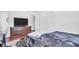 Bedroom with wood floors, a bed, dresser, and a glimpse of the bathroom at 4600 16Th N St, St Petersburg, FL 33703