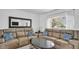 Living room with sectional sofa and modern decor and hardwood floors at 4600 16Th N St, St Petersburg, FL 33703