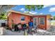 Back patio with seating area next to a terracotta-colored house at 4600 16Th N St, St Petersburg, FL 33703