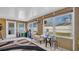Sunroom with windows offering natural light, wooden paneling, small couch, and outdoor access at 4600 16Th N St, St Petersburg, FL 33703