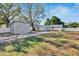 View of the home's backyard, shed, and driveway at 4978 71St N St, St Petersburg, FL 33709