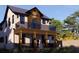 Two-story house with a balcony, dark wood siding, and modern light fixtures at 6266 4Th S Ave, St Petersburg, FL 33707