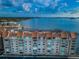 Aerial view of a waterfront condo building with parking and water access at 634 Edgewater Dr # 447, Dunedin, FL 34698
