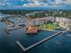 Aerial view showing condo building, marina, and waterfront amenities at 634 Edgewater Dr # 447, Dunedin, FL 34698