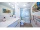 Modern bathroom with walk-in shower and marble vanity at 634 Edgewater Dr # 447, Dunedin, FL 34698