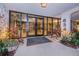 Condo building entry with plants and lighting at 634 Edgewater Dr # 447, Dunedin, FL 34698