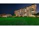 Night view of condo building with lush landscaping at 634 Edgewater Dr # 447, Dunedin, FL 34698