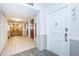 Condo hallway with elevator and apartment door at 634 Edgewater Dr # 447, Dunedin, FL 34698