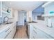 Modern kitchen with white cabinets and stainless steel appliances at 634 Edgewater Dr # 447, Dunedin, FL 34698