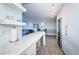 Modern white kitchen with stainless steel appliances and marble countertops at 634 Edgewater Dr # 447, Dunedin, FL 34698