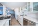 Modern kitchen with white cabinets and granite countertops at 634 Edgewater Dr # 447, Dunedin, FL 34698