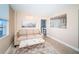 Bright living room with sofa and ottoman, offering an open view of the kitchen at 634 Edgewater Dr # 447, Dunedin, FL 34698