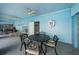 Covered patio area with table and lounge chairs next to pool at 634 Edgewater Dr # 447, Dunedin, FL 34698