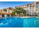 Relaxing community pool area with lounge chairs at 634 Edgewater Dr # 447, Dunedin, FL 34698