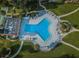 Aerial view of community pool with surrounding lounge chairs at 634 Edgewater Dr # 447, Dunedin, FL 34698
