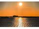 Spectacular sunset over the water with distant buildings at 634 Edgewater Dr # 447, Dunedin, FL 34698