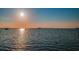 Stunning sunset over calm water with boats at 634 Edgewater Dr # 447, Dunedin, FL 34698