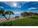 Peaceful waterfront view with benches and palm trees at 634 Edgewater Dr # 447, Dunedin, FL 34698