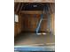 Unfinished basement with concrete floor and a ladder at 809 E Lambright St, Tampa, FL 33604