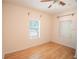 Simple bedroom with wood floors and two windows at 809 E Lambright St, Tampa, FL 33604