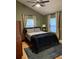 Spacious bedroom with light walls, wood floors, and ceiling fan at 809 E Lambright St, Tampa, FL 33604