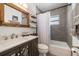 Modern bathroom with gray tile, bathtub, and updated vanity at 8390 64Th N St, Pinellas Park, FL 33781