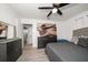 Bright bedroom with ceiling fan, dresser, and comfortable bed at 8390 64Th N St, Pinellas Park, FL 33781