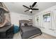 Guest bedroom with a queen bed and floating shelves at 8390 64Th N St, Pinellas Park, FL 33781