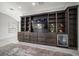 Large, built-in entertainment center with TV, drawers, shelves and a mini fridge at 8390 64Th N St, Pinellas Park, FL 33781