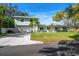 Charming light green house with a two-car garage and landscaped yard at 8390 64Th N St, Pinellas Park, FL 33781