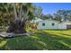 Landscaped yard with large trees and a green lawn at 8390 64Th N St, Pinellas Park, FL 33781