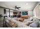 Spacious living room with sectional sofa, large TV, and hardwood floors at 8390 64Th N St, Pinellas Park, FL 33781