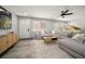 Living room featuring a sectional sofa, large TV, and hardwood floors at 8390 64Th N St, Pinellas Park, FL 33781